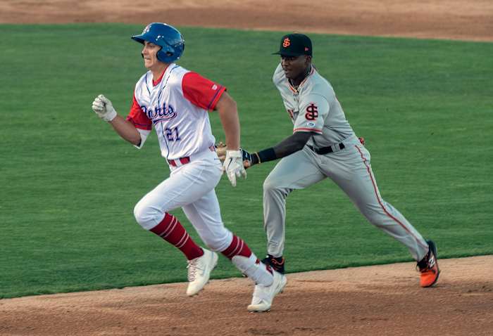 SF Giants prospect Marco Luciano tags A's prospect Tyler Soderstrom.